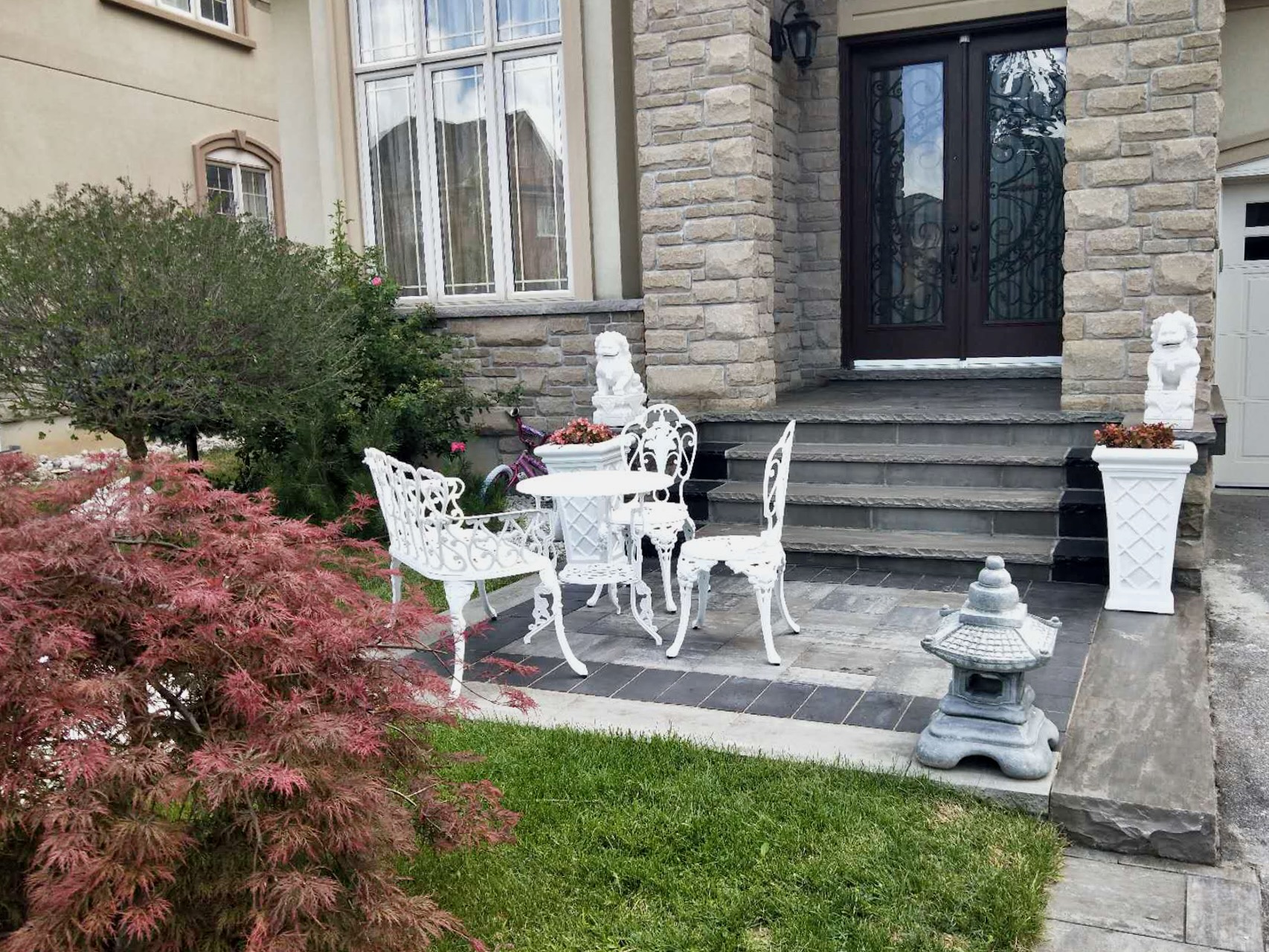 Beautifully landscaped porch with interlocking steps and meticulous garden work