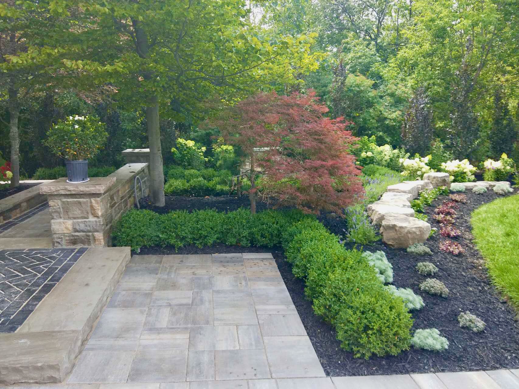 Beautifully landscaped front yard with interlocking steps and meticulous garden work
